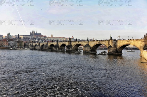 Charles Bridge, Prague, Czech Republic, Europe, Historic bridge over a river in an urban setting with Gothic architecture