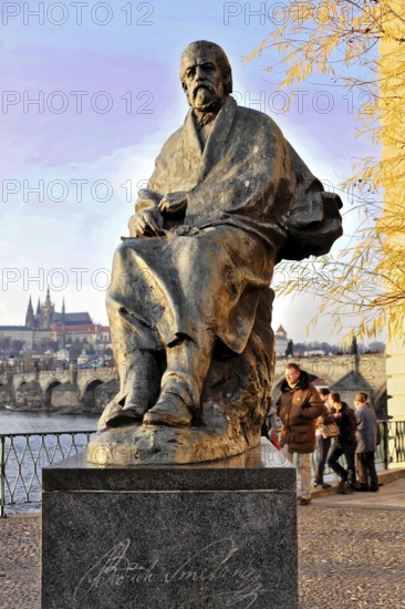 Smetana Monument, Prague, Czech Republic, Europe, Statue of a man on a promenade with people in the background and autumn leaves