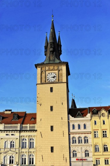 Prague, Czech Republic, Europe, A historic clock tower rises against the blue sky, surrounded by impressive architecture