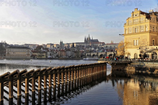 Prague, Czech Republic, Europe, sunlight reflected on the water, Prague in the background, architectural details in the foreground