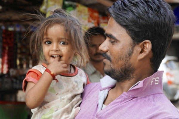Kota, Rajasthan, North India, Asia, man carrying a little girl, both seem to have fun and smile, India