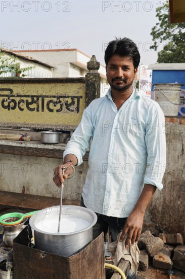 Kota, Rajasthan, North India, Asia, A vendor boiling milk in a pot on the street in a rural area, India
