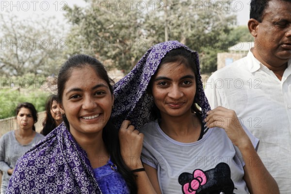 Kota, Rajasthan, North India, Asia, Two smiling woman with headscarves pose friendly in nature, India
