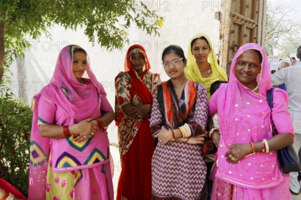 Kota, Rajasthan, North India, Asia, Group of woman in traditional dress standing under a tree, India