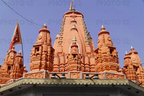 Kota, Rajasthan, North India, Asia, Bright red temple tower with Hindu architecture in the blue sky, India