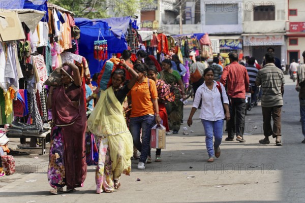 Kota, Rajasthan, North India, Asia, Lively market with people of different ages between colourful stalls, India