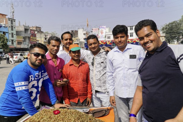 Kota, Rajasthan, North India, Asia, Group of men in sunny weather in an urban environment, radiating conviviality and joy, India