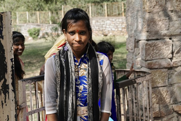 Kota, Rajasthan, North India, Asia, Young woman in traditional clothes looking into the camera, friendly atmosphere, India