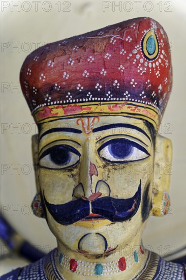 Udaipur, Rajasthan, North India, India, Asia, Traditional wooden figure with moustache and detailed headgear in bright colours