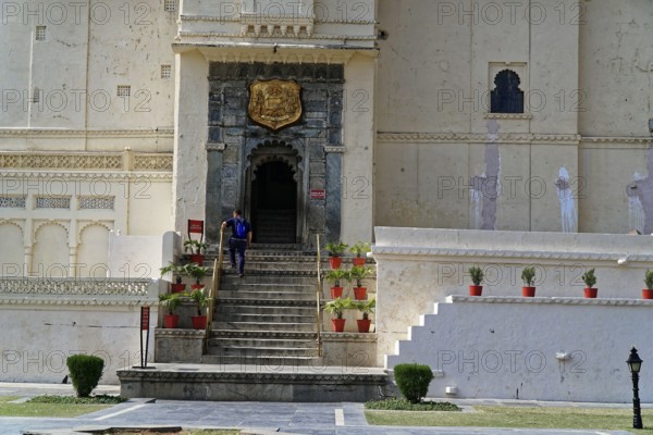 City Palace, Udaipur, Rajasthan, India, Asia, Historic palace entrance in Rajasthan with stairs, plants and decorative elements, North India