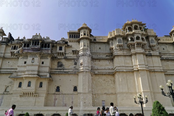 City Palace, Udaipur, Rajasthan, India, Asia, Magnificent Indian palace made of sandstone with decorations and tourists in the foreground, North India