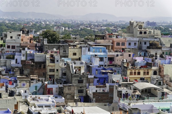 Udaipur, Rajasthan, North India, Asia, Urban view in India with dense buildings and colourful houses surrounded by hills