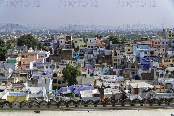 Udaipur, Rajasthan, North India, Asia, Dense city view in India with colourful buildings and hills in the background