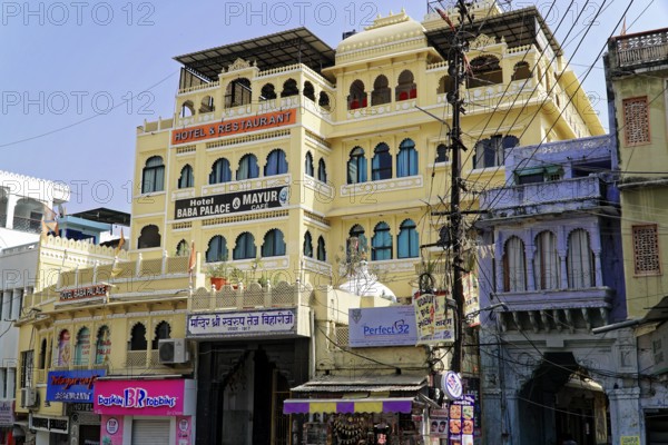 Udaipur, Rajasthan, North India, Asia, A bustling hotel building with Indian architecture and street scene below, colourful and vibrant