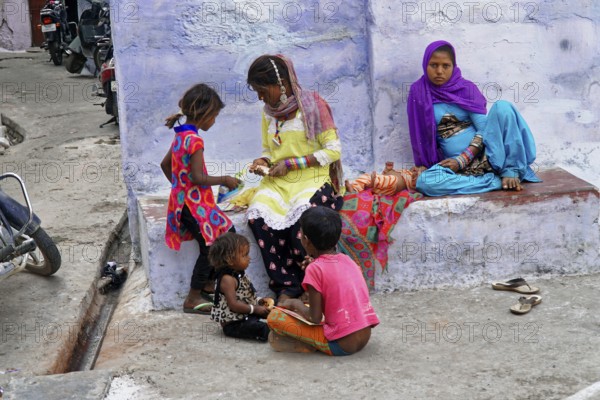 Udaipur, Rajasthan, North India, India, Asia, Group of children in colourful clothes playing and laughing on a street