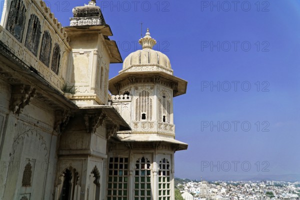 City palace, Udaipur, Rajasthan, India, Asia, Close-up of a palace with ornate domes and windows under a clear sky, North India