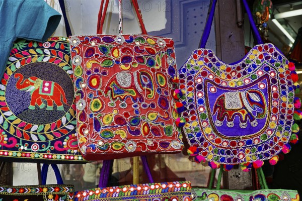 Udaipur, Rajasthan, North India, Asia, Different coloured embroidered bags with elephant patterns hang on display