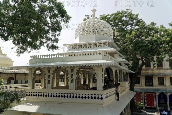 Udaipur, Rajasthan, North India, Asia, White pavilion with ornate decorations and surrounded by green trees