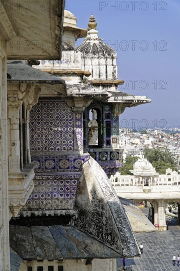 City Palace, Udaipur, Rajasthan, India, Asia, Detailed masonry of a palace with blue and white tiles and view of the city, North India
