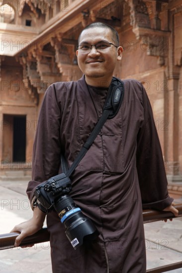 Red Fort, Agra, Uttar Pradesh, India, Smiling man with camera in front of decorated historical building, Jodhpur, Rajasthan, North India