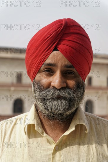 Red Fort, Agra, Uttar Pradesh, India, man with turban and beard smiling warmly, traditionally dressed with plain background, Jodhpur, Rajasthan, North India