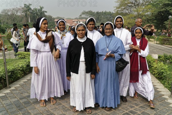 Agra, Jodhpur, Rajasthan, North India, Asia, Group of smiling nuns in religious dress on a pavement