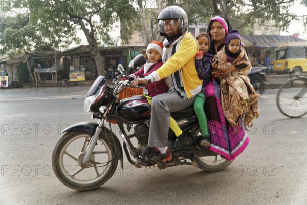 Agra, Jodhpur, Rajasthan, North India, Asia, family with three children on a motorbike on a busy street
