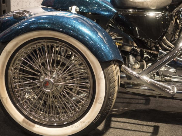 Shiny motorbike wheel with chrome spokes and white-walled tyres, dortmund, deutchland