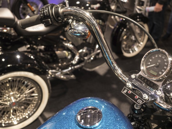 Retro motorbike handlebars with display and shiny chrome details on blue tank, dortmund, deutchland
