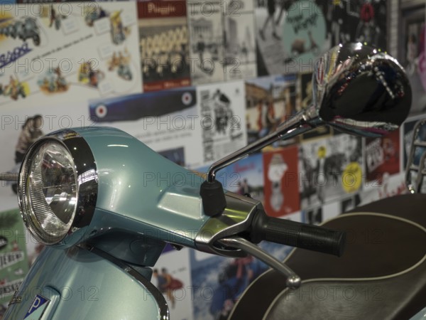 Retro scooter in blue with a chrome mirror, surrounded by billboards in the background, dortmund, deutchland
