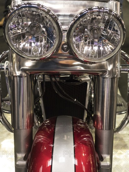 Close-up view of round chrome headlights of a motorbike with red elements, dortmund, deutchland