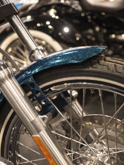Close-up of a motorbike tyre with wire spokes and chrome rim, Dortmund, Germany