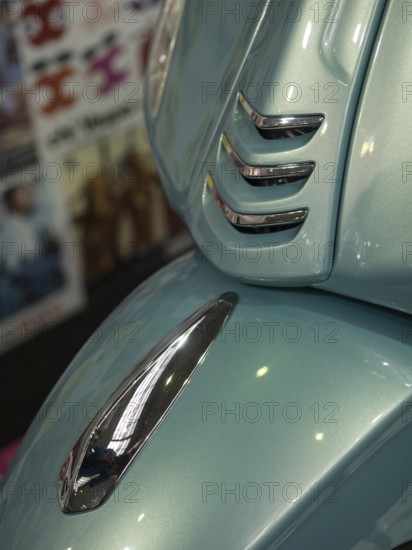 Close-up of a blue vintage-style scooter with chrome trim and shiny paintwork, dortmund, deutchland