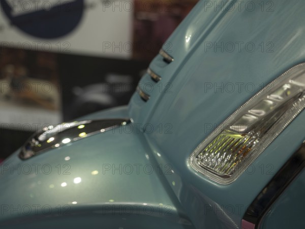 Close-up of a blue retro scooter with chrome accents and reflective surfaces, dortmund, deutchland
