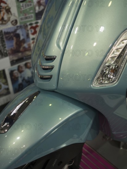 Front of a blue scooter in retro style with glossy paint and shiny chrome details, dortmund, deutchland
