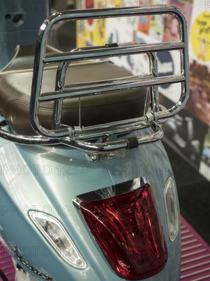 Blue scooter with chrome luggage rack and brown seat in retro design, dortmund, deutchland