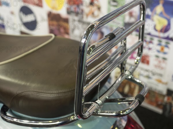 Brown motorbike seat with chrome luggage rack in front of colourful wall, dortmund, deutchland