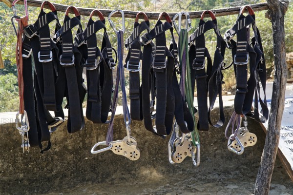 Climbing harnesses and ropes hanging ready for use on a wooden frame, Ranakpur, Jodhpur, Rajasthan, North India