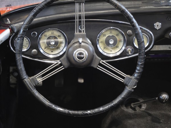 A stylish steering wheel in a classic car, featuring a retro feel and classic instruments, Cologne, Germany