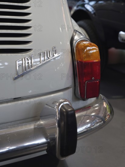 Detail of a white vintage car with tail light and bumper, gives a feeling of vintage elegance, Cologne, Germany