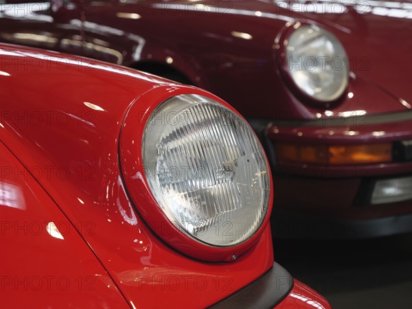 Front view of two classic red Porsches, showing elegant style, Cologne, Germany