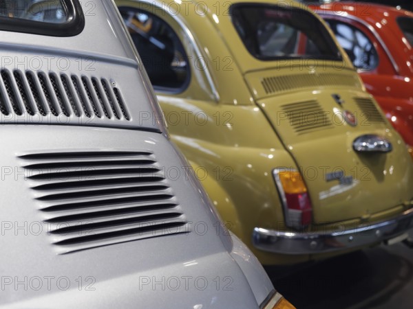 Close-up of colourfully painted vintage cars parked next to each other, creating a nostalgic feeling, Cologne, Germany