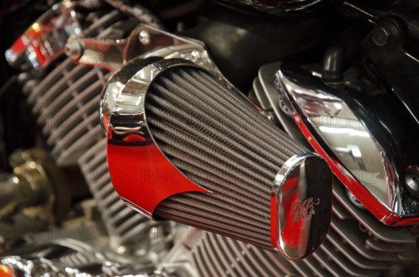 Detailed view of a metallic air filter and engine part of a motorbike, dortmund, germany
