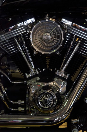 Shiny motorbike engine with shiny chrome components and central fan, dortmund, germany