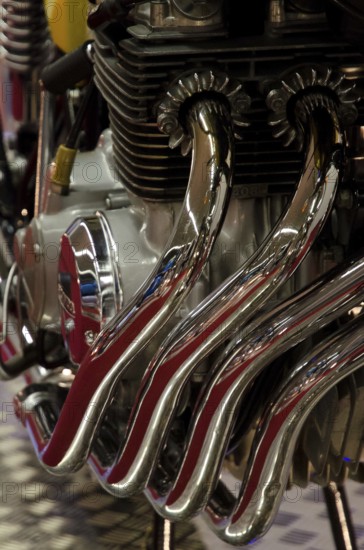 Close-up of shiny metal pipes and engine parts with a focus on mechanical beauty, dortmund, germany