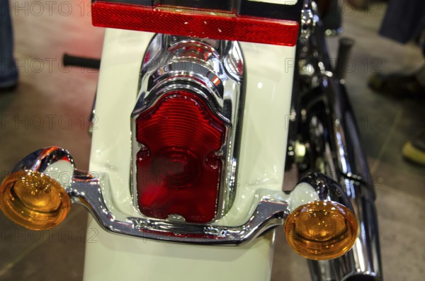 Close-up view of a motorbike tail light with chrome-coloured details and a white housing, dortmund, germany