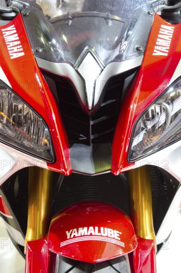 Sporty Yamaha motorbike in red and white colour with distinctive headlights and logos, dortmund, germany