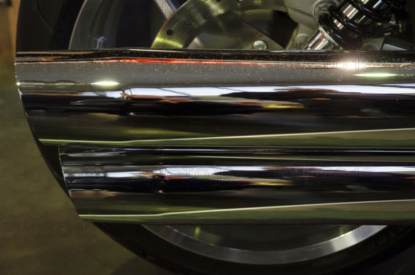 Close-up of a chrome-plated motorbike exhaust with shiny surface and reflections, dortmund, germany
