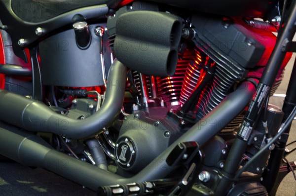 Detailed image of a motorbike engine block with red illuminated components, dortmund, germany