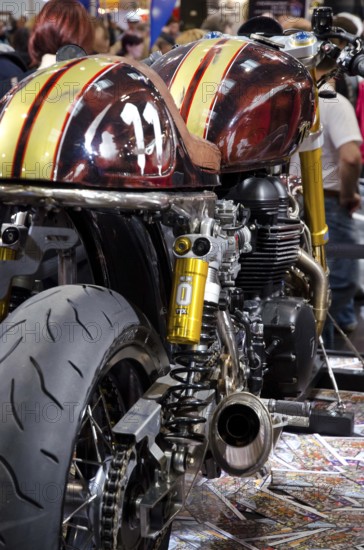 Detail of a customised machine with yellow racing stripes and exhaust, dortmund, germany